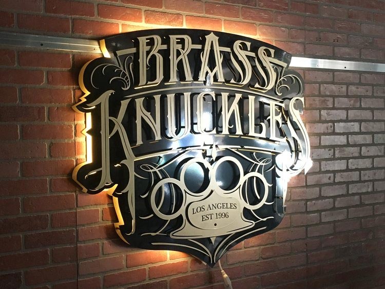 Brass Knuckles backlit sign